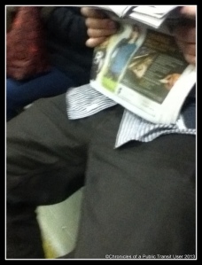 Taking up 2 seats while reading his paper.  Thinks he is at home.